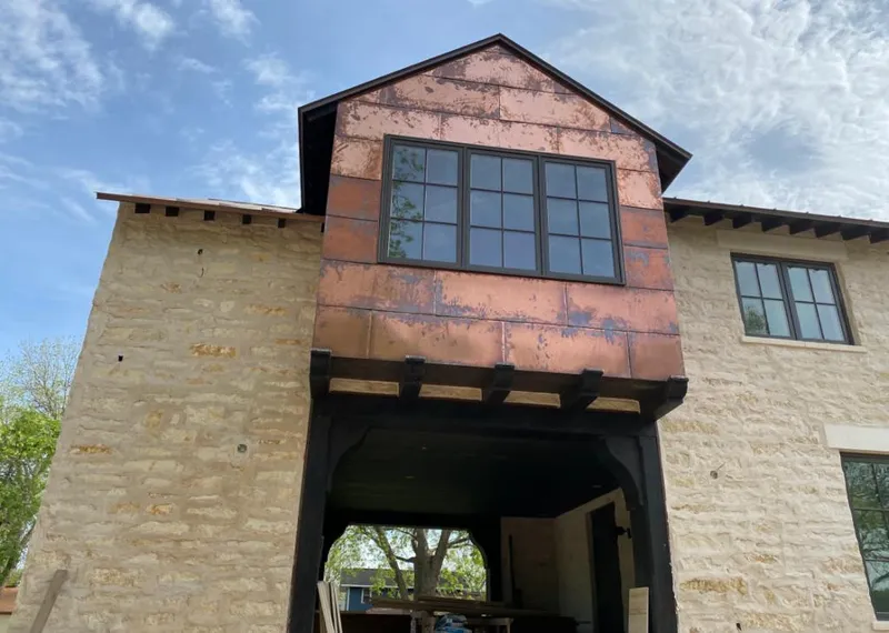 Copper metal panel facade on a stone building for Metal Roof Coating in Ashburn