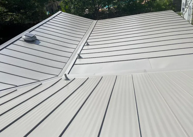 Solar attic fan installed on a metal roof for Roof Ventilation in Ashburn